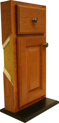 Cabinet refacing display on a stand, showing a drawer front, a door and the refaced cabinet frame
